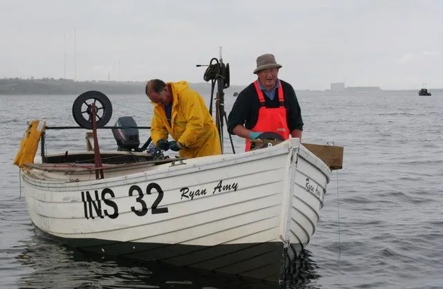 A fishing crew working a longline at sea